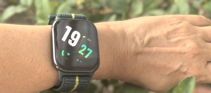 Motorola Moto Watch Fit com fundo de arbusto